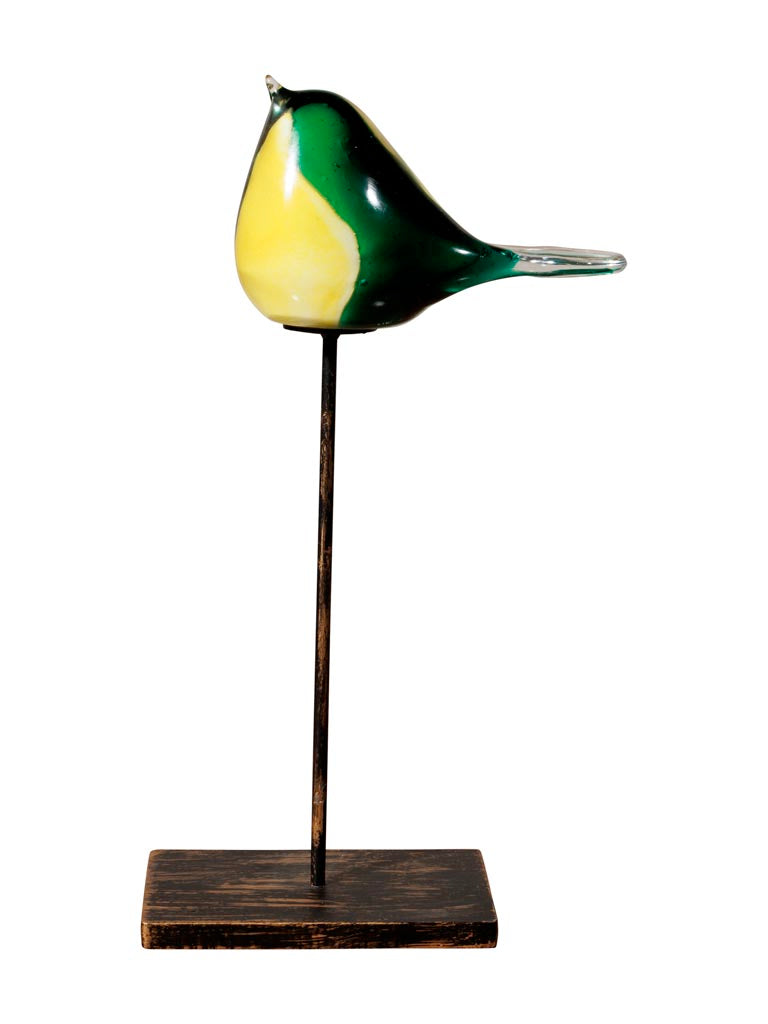 Green and yellow glass bird on stand